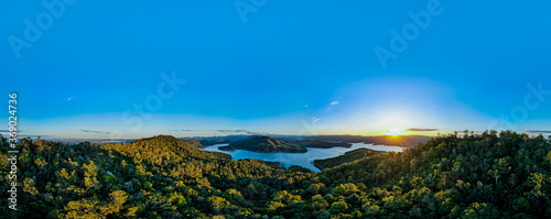 Natural Lake Aerial Panorama with Mountain Landscape and Forest Background Reflection of Clouds on rippling water. Scenic Relaxing Scenery on a clear Summer Day 4K HD High Definition 