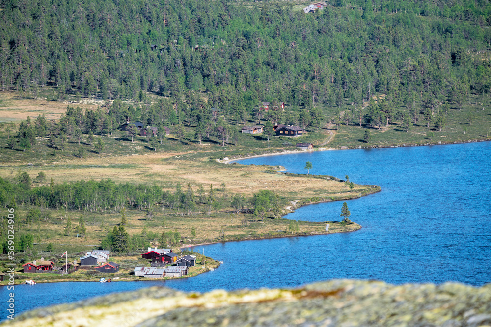 Furusjoen lake and cabins in Rondane national park in Norway during day and sunny weather. Travelling and holiday concept.