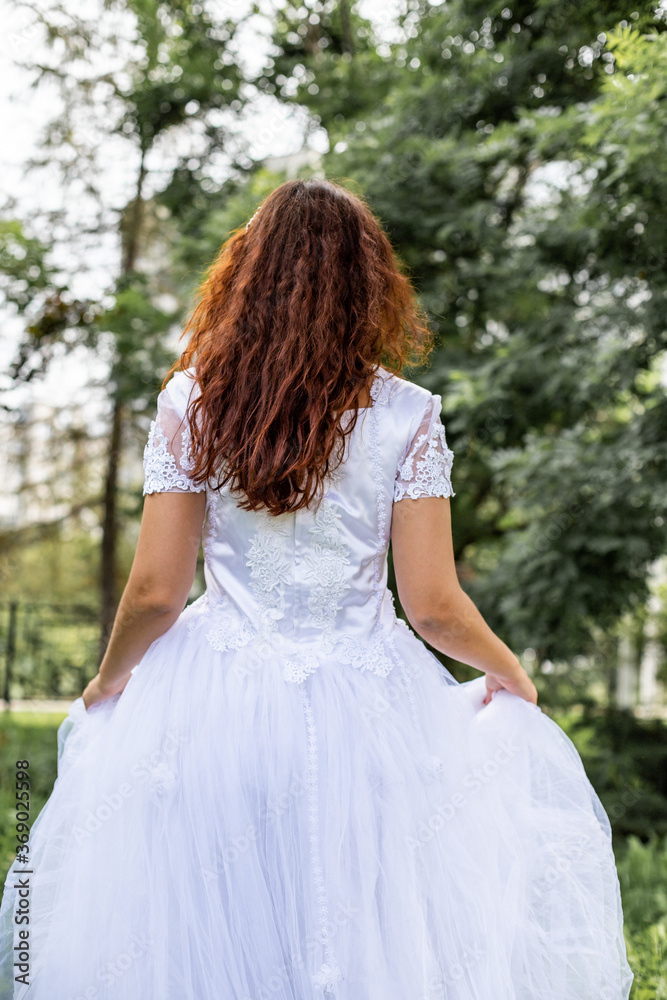 bride in a white dress in the park