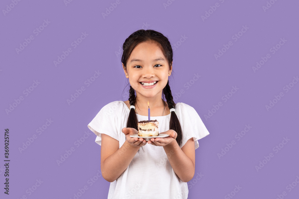 Happy Asian Girl Holding B-Day Cake Making Wish, Purple Background Happy Asian Girl Holding B-Day Cake Making Wish, Purple Background