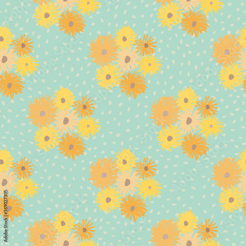 Summer chrusanthemum ornament seamless pattern. Light ble dotted background with flower shapes in yellow and orange tones. photo