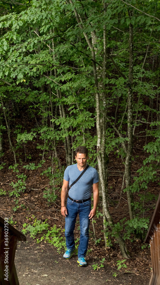 Man hiking in the forest in summer Man hiking in the forest in summer
