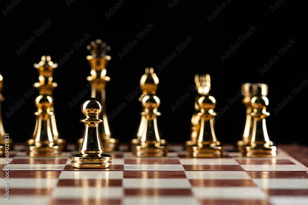 Golden chess figures standing on chessboard Golden chess figures standing on chessboard