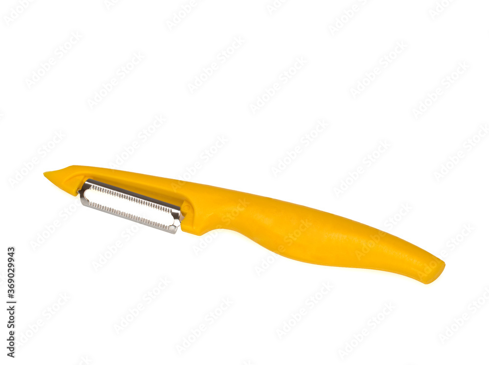 Yellow peeler on white background. Knife, peeler for vegetables and fruits Yellow peeler on white background. Knife, peeler for vegetables and fruits