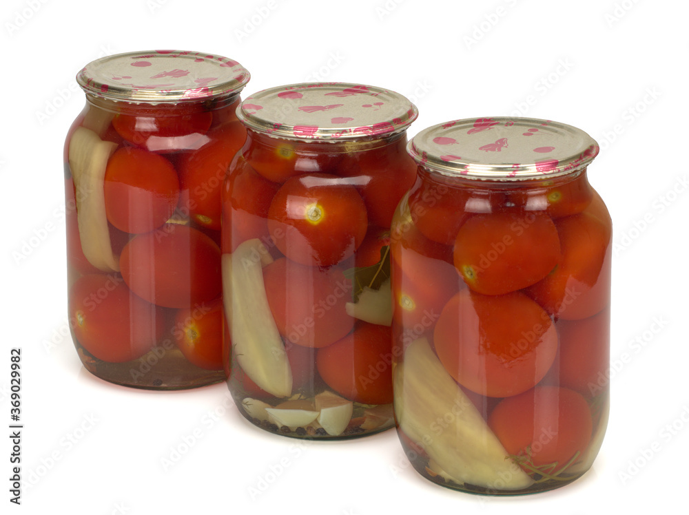 Canned and preserved tomatoes in glass jar isolated on white. Homemade pickled vegetables. Canned and preserved tomatoes in glass jar isolated on white. Homemade pickled vegetables.