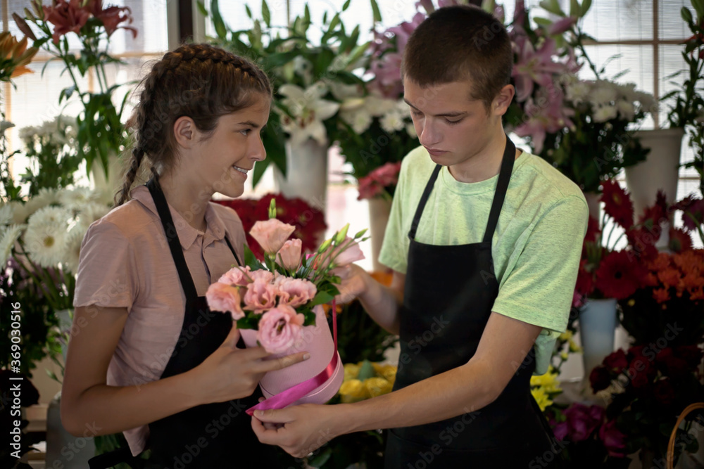 young florists work in a flower shop