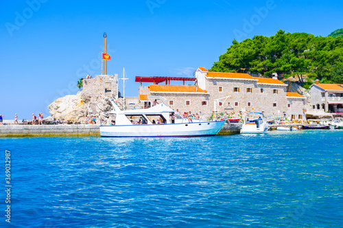 The tourist boasts in harbor of Petrovac town, Montenegro photo