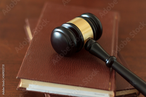 Judge's gavel lying on law books. Top view