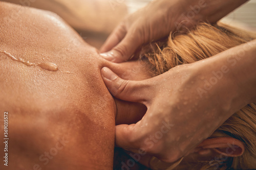 Foto Professional therapist doing neck massage to woman in beauty salon