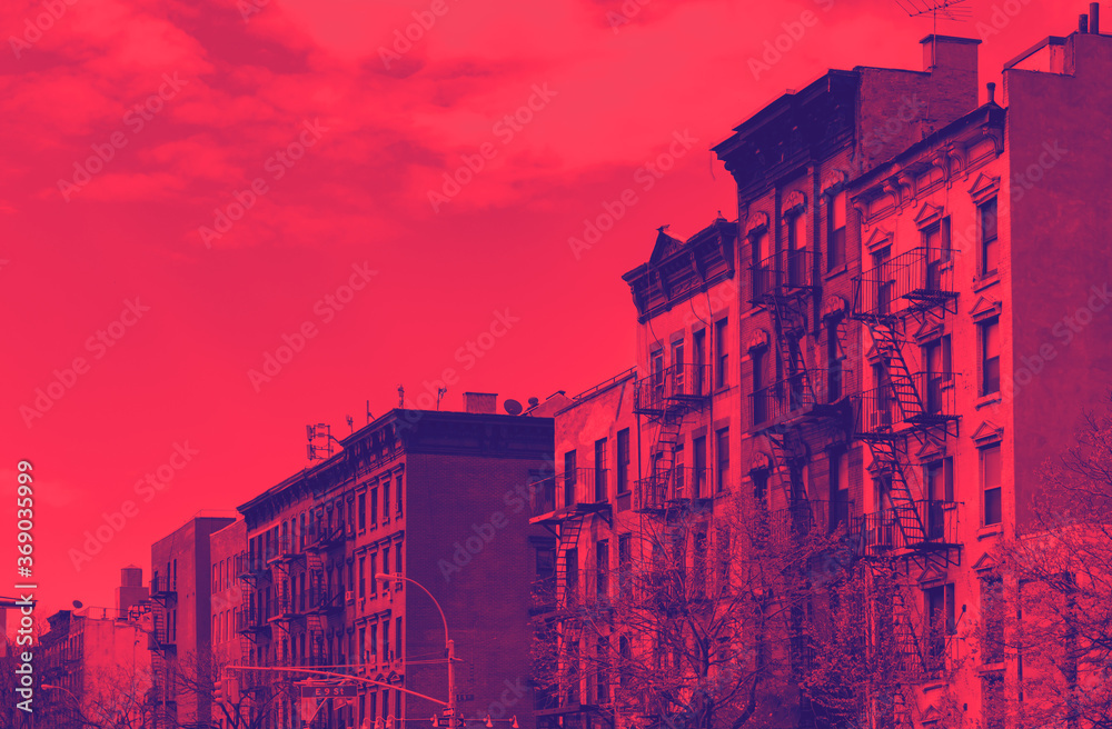 Block of old buildings in the East Village neighborhood of New York City with red and blue duotone color effect
