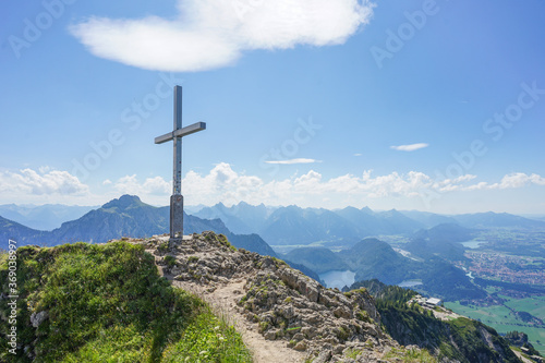 Summit cross in the mountains of Bavaria, Germany on top of the mountain "Branderschrofen" on a sunny summer day
