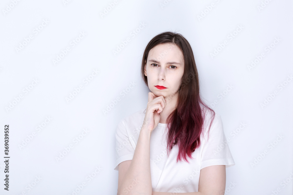 Young woman with red lipstick looks thoughtfully. Copy space Young woman with red lipstick looks thoughtfully. Copy space