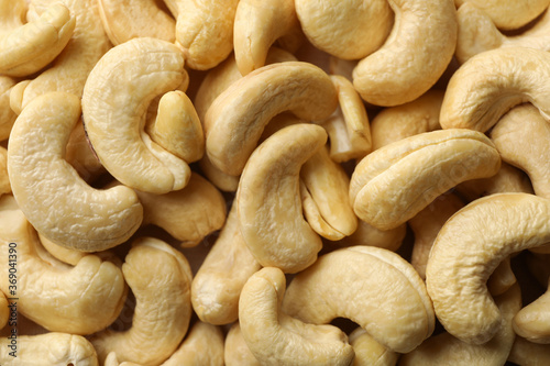 Tasty cashew nuts on whole background. Vitamin food