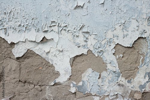 Weathered shabby peeled concrete surface white painted wall texture pattern macro