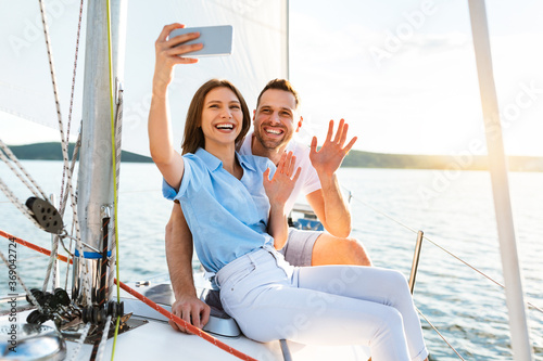 Couple On Yacht Making Selfie Enjoying Cruise At Seaside © Prostock-studio