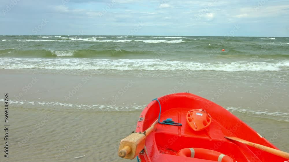 Timelapse of surfing waves on sea. Red baywatch boat in on beach. Rescue concept. Timelapse of surfing waves on sea. Red baywatch boat in on beach. Rescue concept.