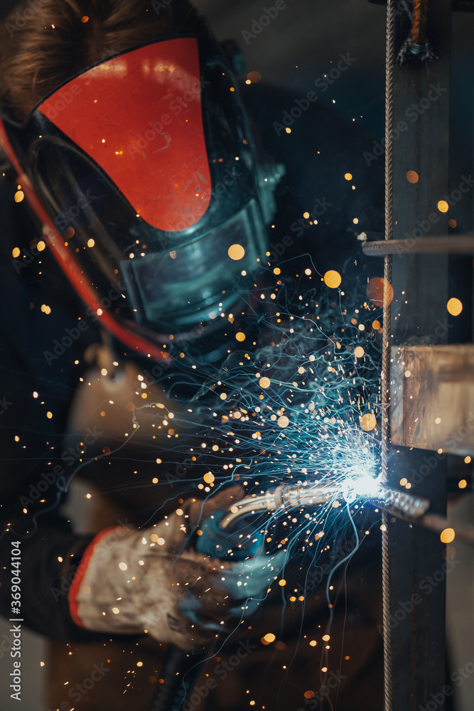 Experienced welder works in the factory Experienced welder works in the factory