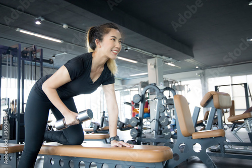 Asian women are exercising in the GYM to lose weight and keep their bodies in good shape.