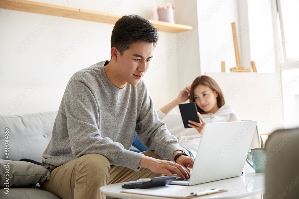 young asian couple staying at home during coronavirus pandemic young asian couple staying at home during coronavirus pandemic
