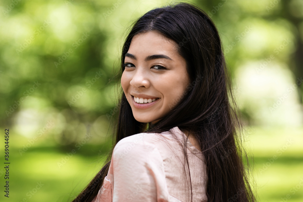 Outdoor Portrait Of Beautiful Smiling Asian Girl Turned At Camera, Closeup Outdoor Portrait Of Beautiful Smiling Asian Girl Turned At Camera, Closeup