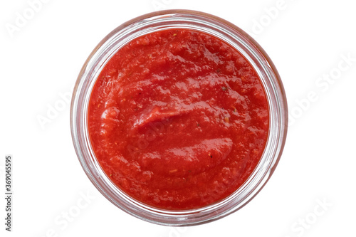 Red tomato sauce in a glass bowl isolated on a white background, top view
