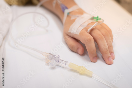 Close-up of 3-way pipe connected to the saline solution tube for intravenous infusion saline solution to patients in a hospital bed