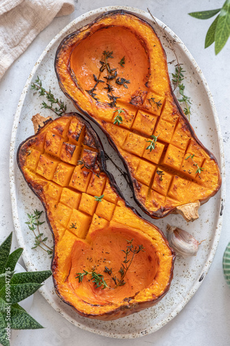 Tray with roasted butternut squash pumpkin and herbs photo