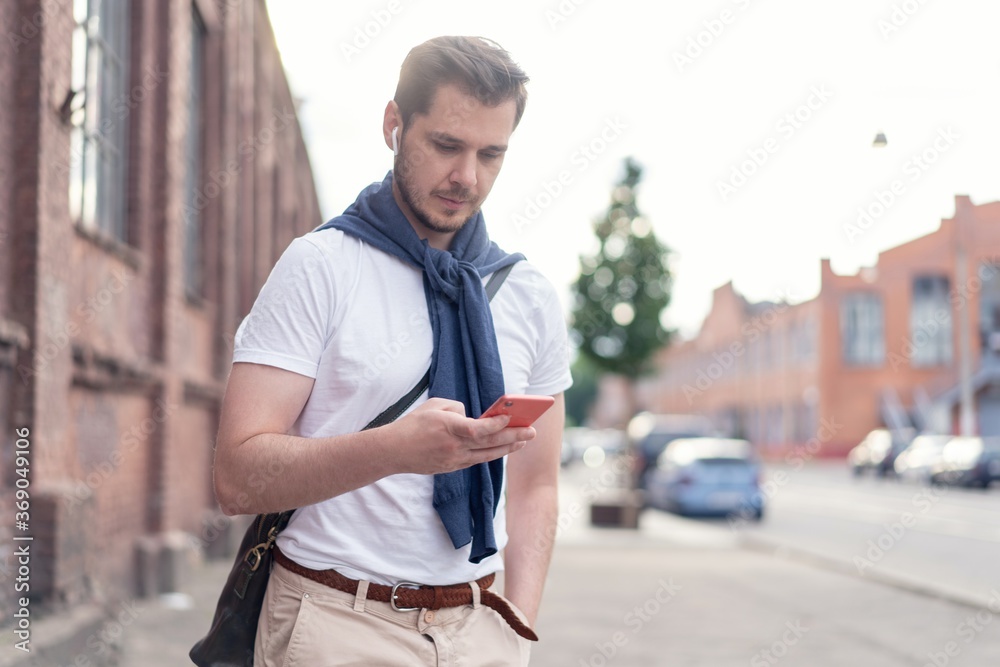 handsome hipster modern man using smart phone in the city handsome hipster modern man using smart phone in the city