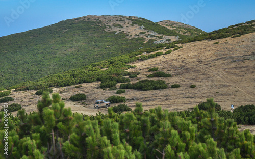 Off road car driving through Cindrel National Park. Autumn.