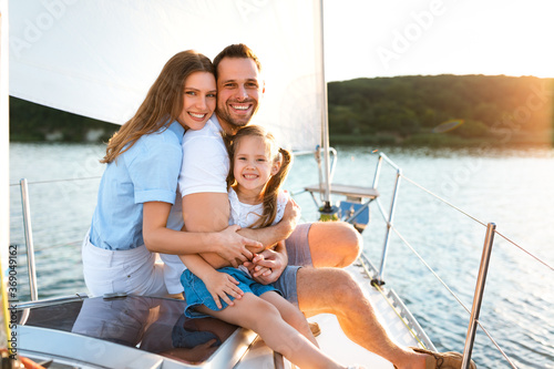 Family Sitting On Yacht Embracing Enjoying Sea Travel Outdoors © Prostock-studio