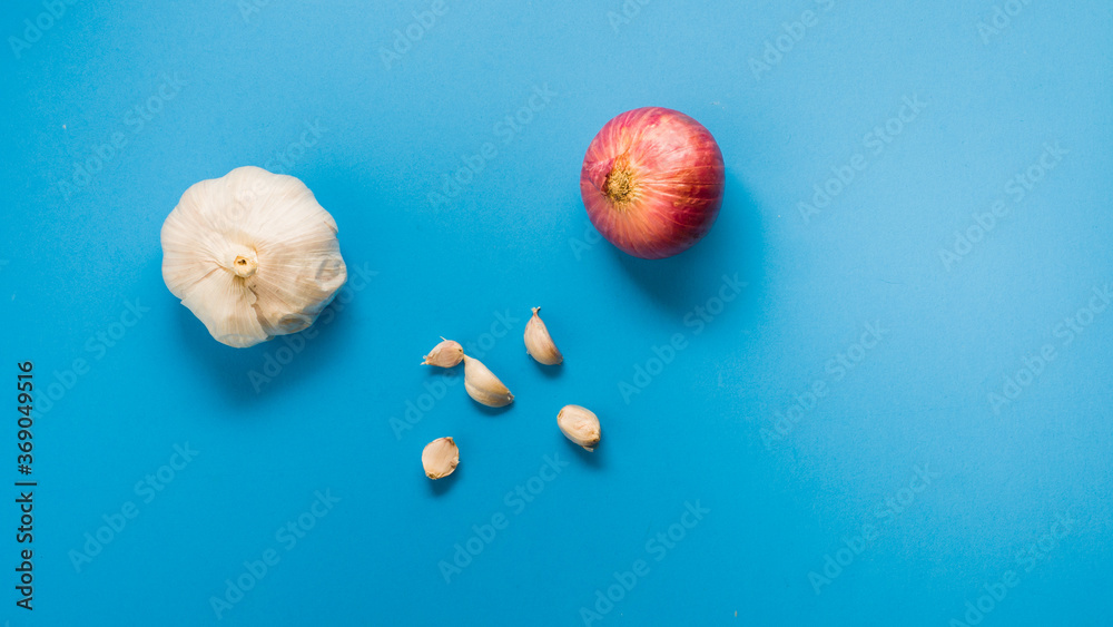 Garlic and onions spices with blue background Garlic and onions spices with blue background