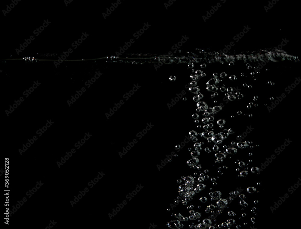 Bubble soda and white oxygen air, in underwater clear liquid with bubbles flowing up on the water surface, On a black background