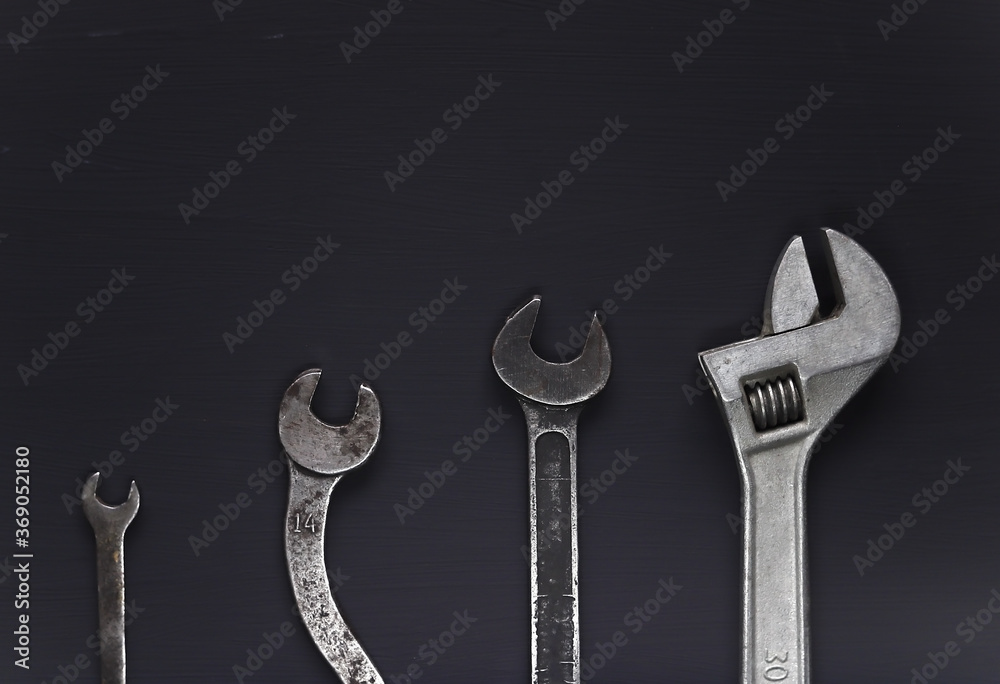 A set of wrenches of different sizes on a gray background. A set of wrenches of different sizes on a gray background.