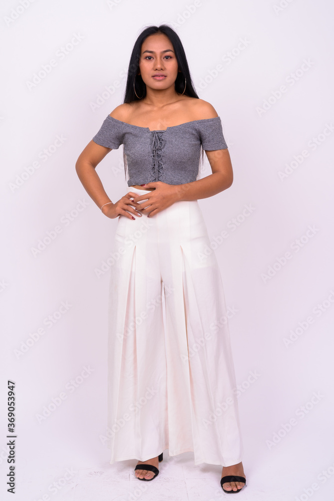 Young beautiful Asian woman against white background Young beautiful Asian woman against white background