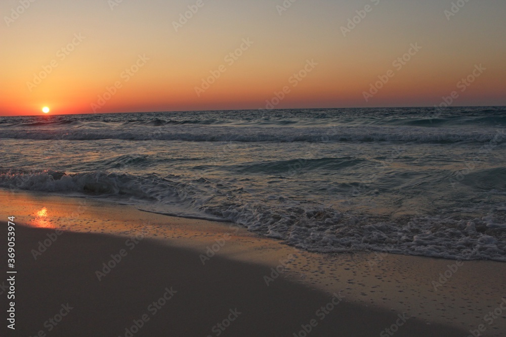 Sunset on the sea shore in Alexandria with orange horizon in Egypt