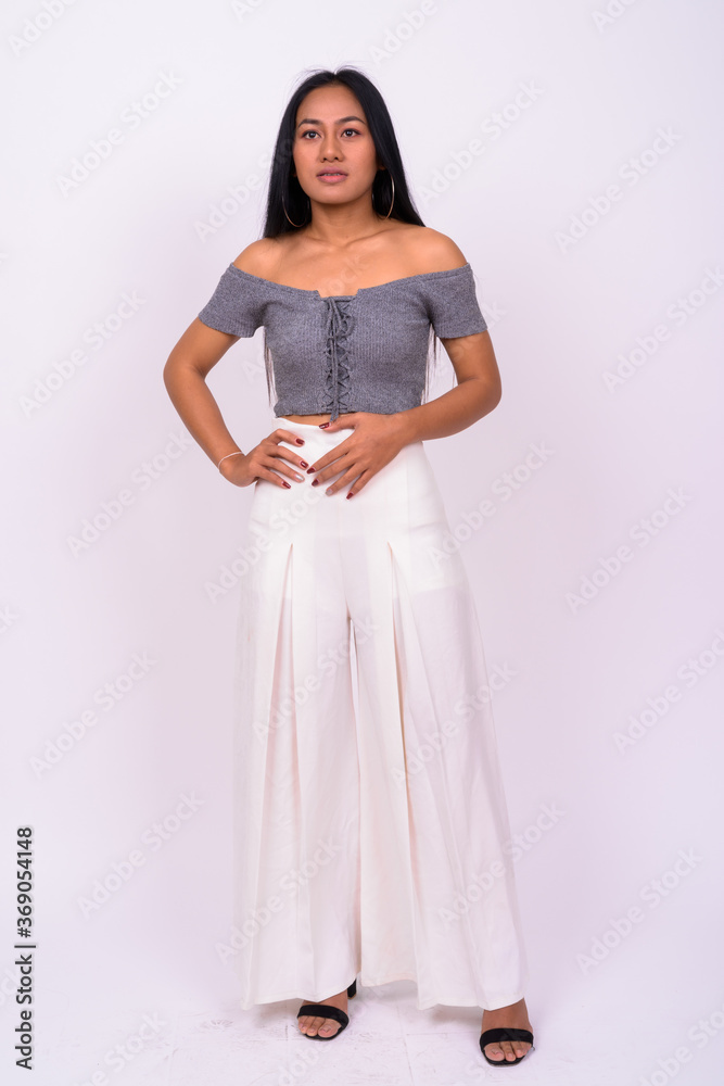 Young beautiful Asian woman against white background Young beautiful Asian woman against white background