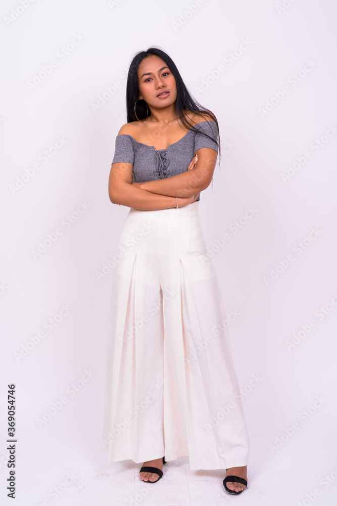 Young beautiful Asian woman against white background Young beautiful Asian woman against white background