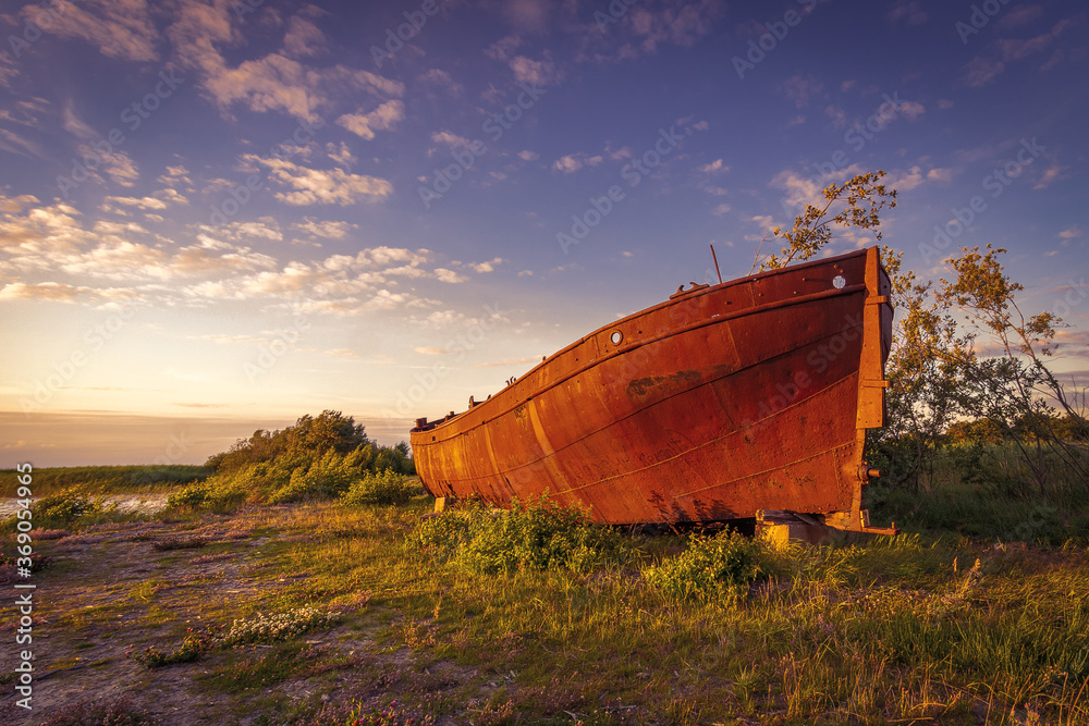 Lonely rusty ship lies deserted on the shore. Lonely rusty ship lies deserted on the shore.
