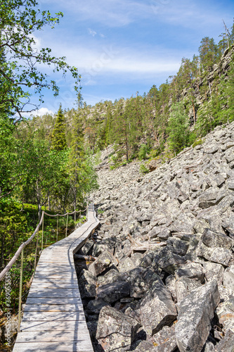 View of The Pyha-Luosto National Park in summer, wooden walkway and rocks, Lapland, Finland photo