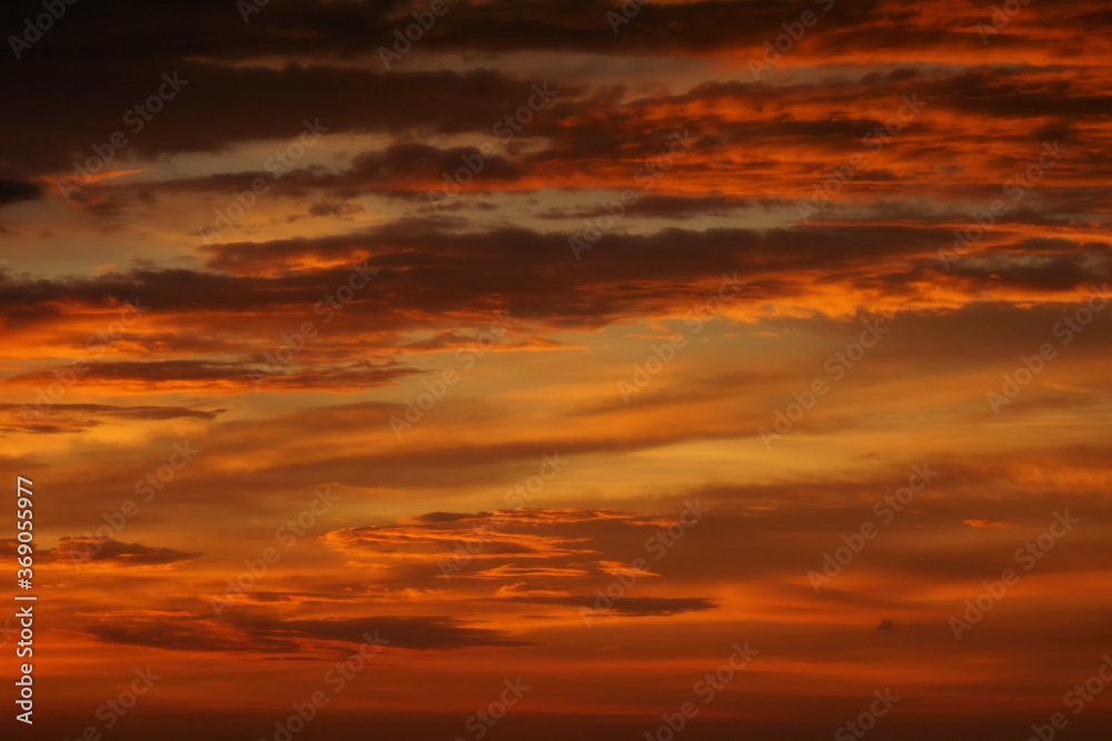 Sunset lighting and orange sky with cloud as background