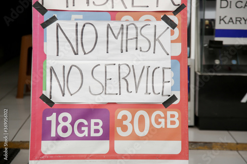 No mask no service sign in front of the shop. Safety measures during coronavirus. New normal concept.