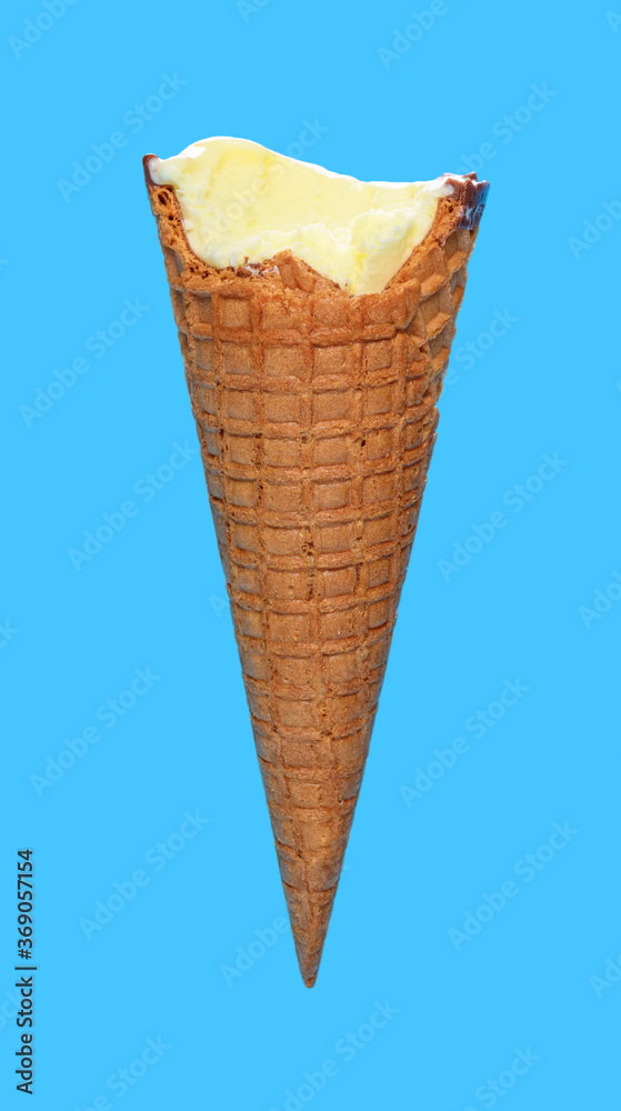 side view vanilla flaovr ice cream cone with couple of bites on a blue background side view vanilla flaovr ice cream cone with couple of bites on a blue background