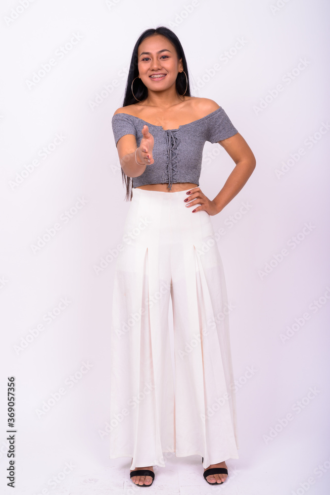 Portrait of happy young beautiful Asian woman with braces