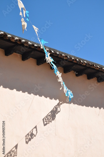 decorating confetti mexico carnival flag banner garland at sunny sky background