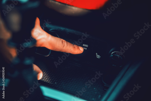 Man activating 4WD lock on a modern SUV photo