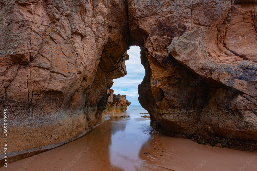 Natural rock Arch at the Beach at cove bay on the Moray coast, Scotland.