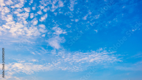 Blue summer sky with soft clouds as a background