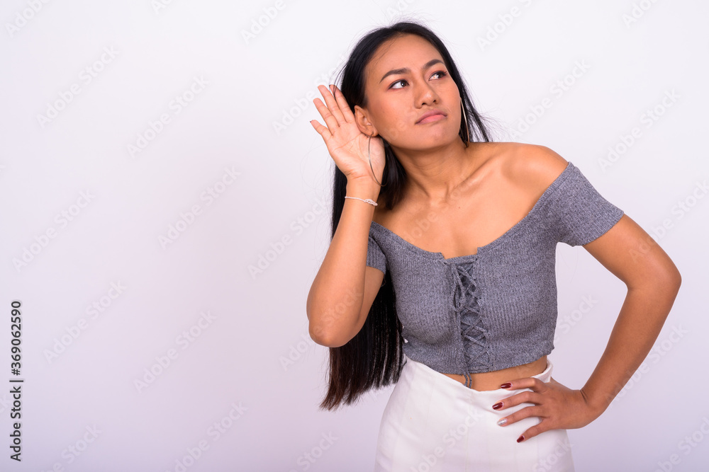 Young beautiful Asian woman against white background Young beautiful Asian woman against white background