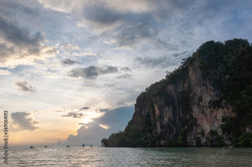 Early sunrise with Andaman Sea and rocks overgrown with forest