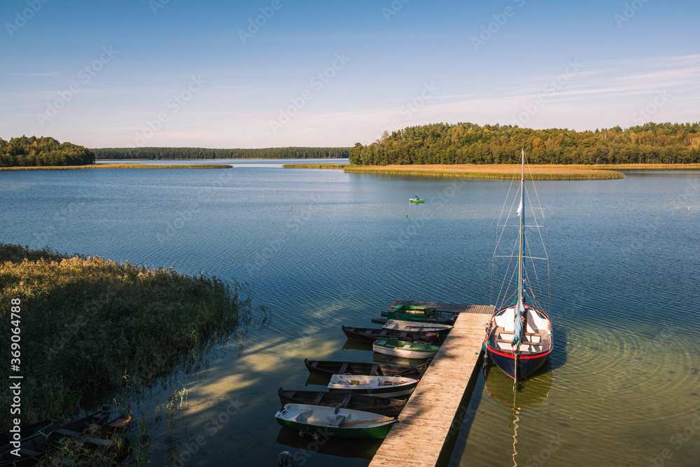 Sailboat and fishing boats on the Wigry lake near Wigierski National Park, Podlaskie, Poland